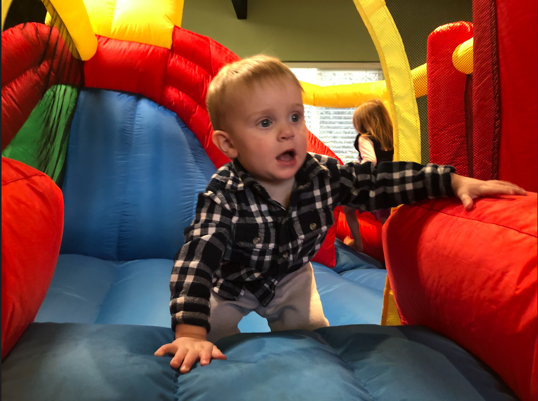 A young toddler in a small bounce house